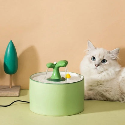 fontaine a eau pour chat ceramique silencieuse et hygiénique 1.5L avec bec en forme plante décoratif avec champignon et chat reposé à côté